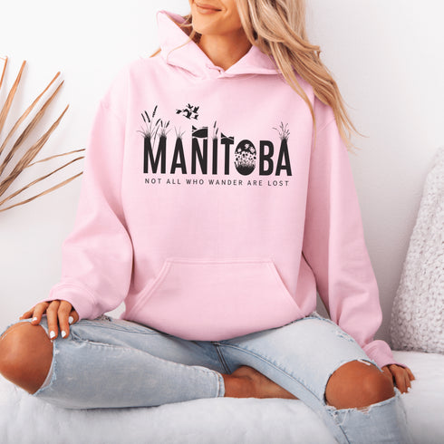 Featuring a serene prairie landscape, the design captures the essence of the heartland with wildflowers and prairie grasses growing out of the letters Manitoba.